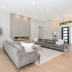 Bright, airy living space 🤍 featuring soft neutral tones, plush seating, and a sleek modern fireplace that brings warmth and elegance together.