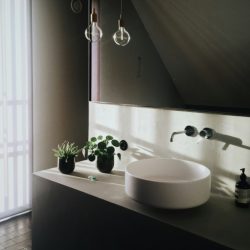 Moody modern elegance 🖤 with soft natural light, a sleek vessel sink, and warm accents creating a calm, sophisticated space.